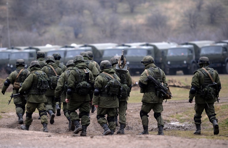 TOPSHOTS Russian soldiers patrol the area surrounding the Ukrainian military unit in Perevalnoye, outside Simferopol, on March 20, 2014. Kiev will never recognise Russia's annexation of Crimea and will fight for the "liberation" of the strategic Black Sea peninsula, Ukraine's parliament said in a resolution adopted on March 20. AFP PHOTO/ Filippo MONTEFORTE