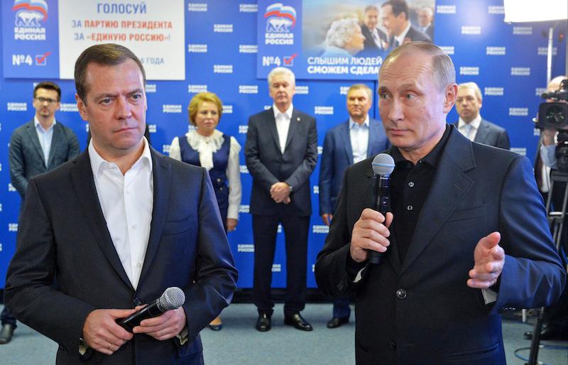 Vladimir Putin and Dmitry Medvedev announce their “victory.”