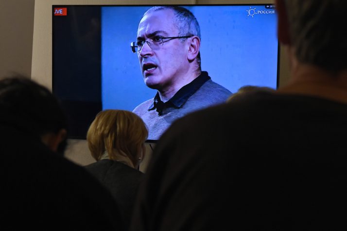 Top Kremlin critic Mikhail Khodorkovsky is seen on a screen as he speaks via live video conference with journalists at the Open Russia movement office in Moscow on December 9, 2015. Russian investigators have summoned Kremlin critic Mikhail Khodorkovsky for questioning over a 1998 murder, the website of the former head of Yukos oil company said on December 8. AFP PHOTO / VASILY MAXIMOV / AFP / VASILY MAXIMOV (Photo credit should read VASILY MAXIMOV/AFP/Getty Images)